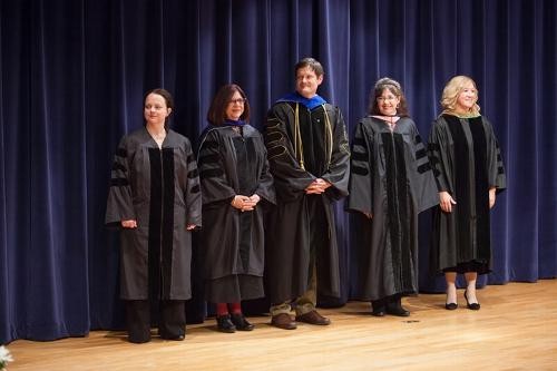 Faculty members line up and wait to be honored during ceremony